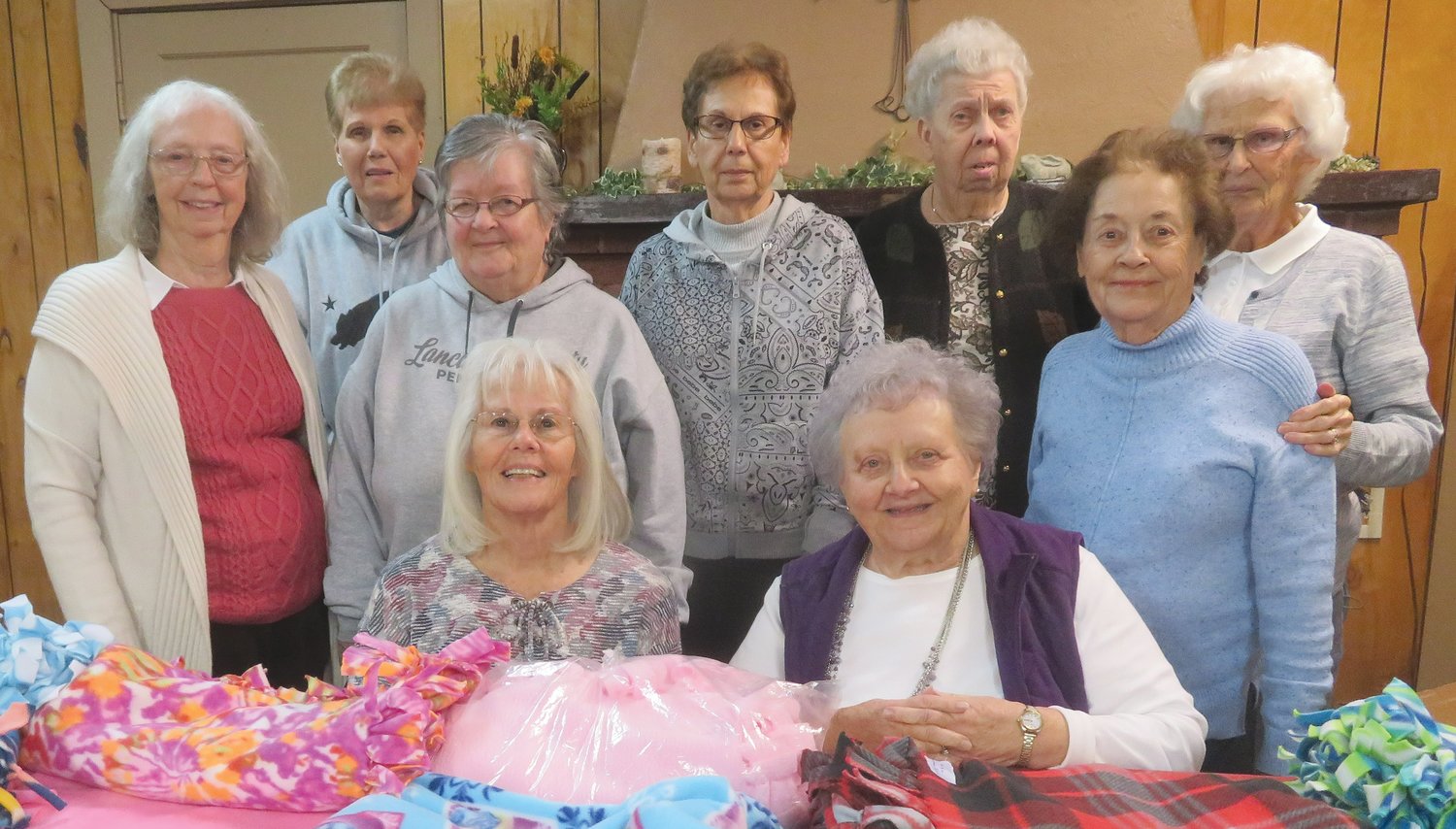Members of the Maple Grove Extension Homemakers pose with fleece blankets.